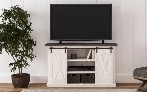 A wooden TV stand with a light cream-colored rustic finish