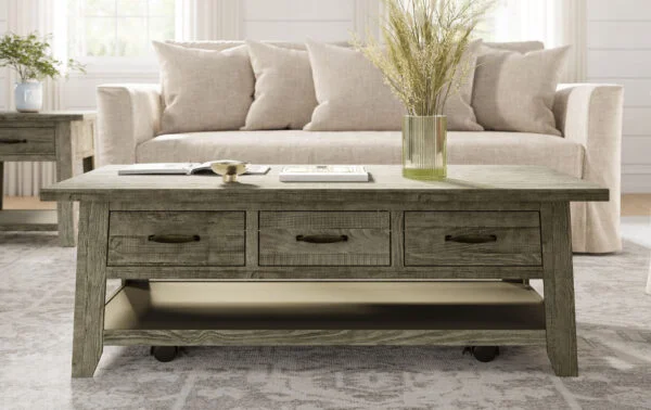 a coffee table with built-in drawers in a family room and home office combination space