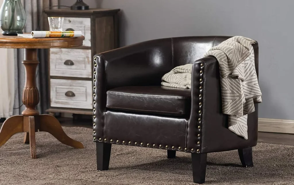 brown leather barrel chair with metal trim detailing
